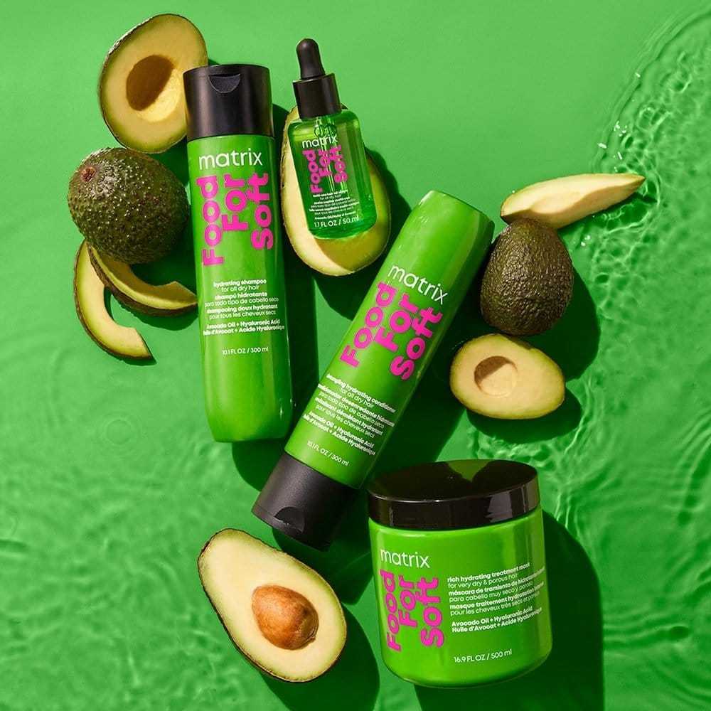 Matrix haircare products with avocados on a vibrant green background.