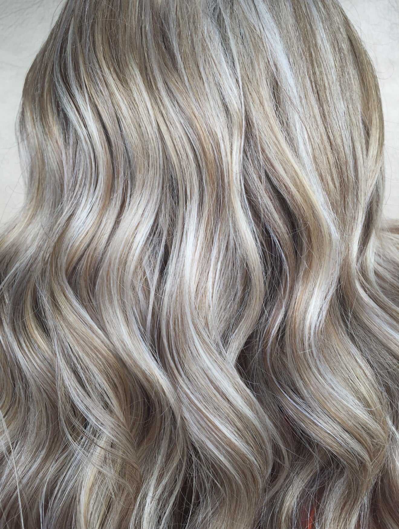 Wavy blonde hair with highlights, close-up view showcasing texture and color.