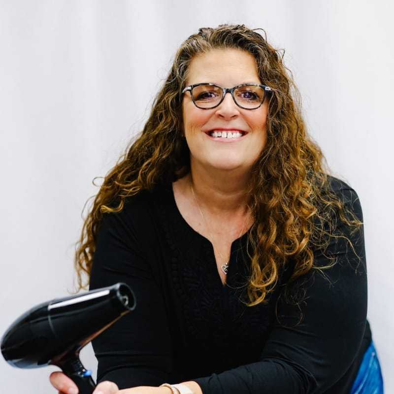 Portrait of Tracy, a professional stylist at LookAfter Hair, showcasing their expertise and style.