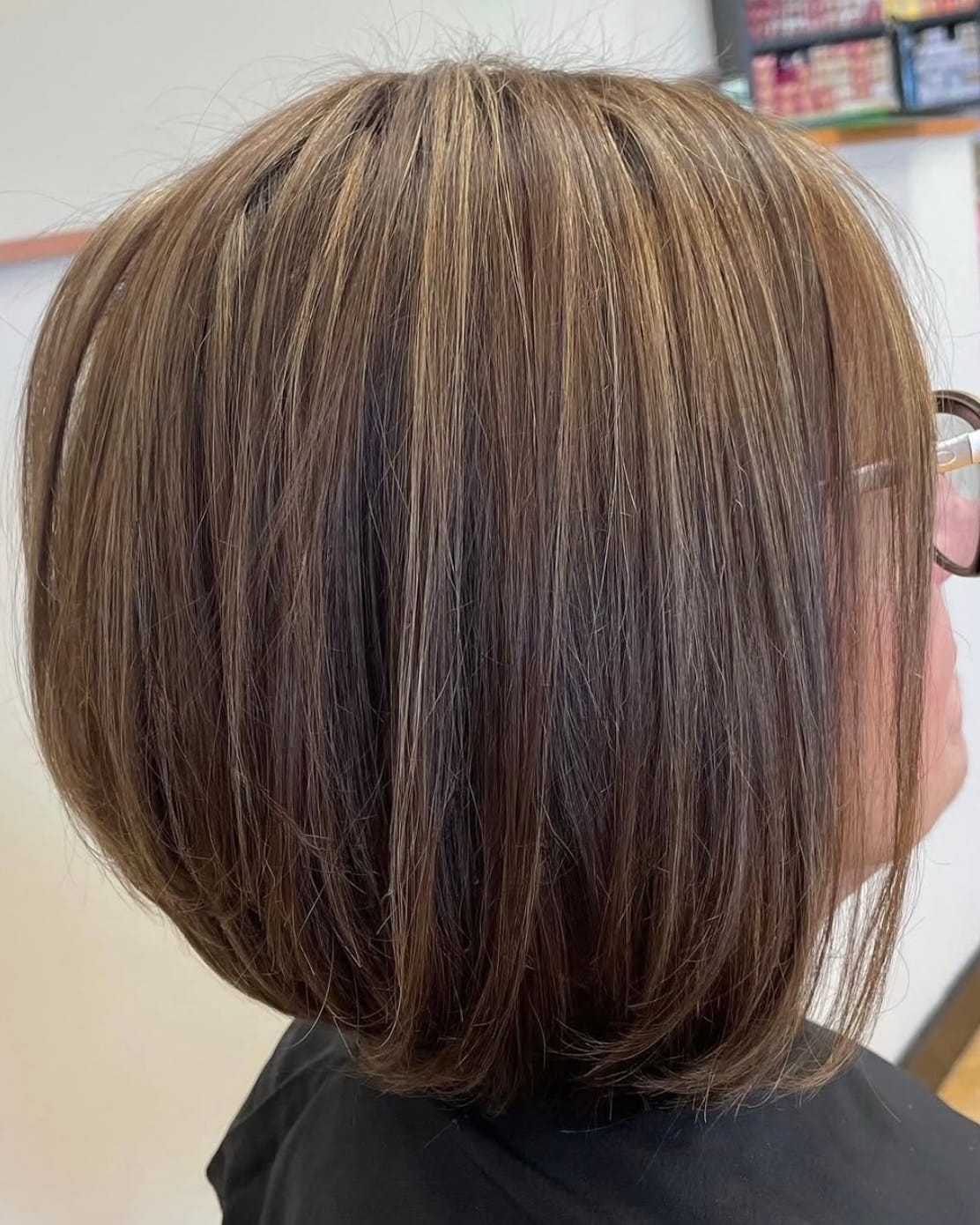 Bob haircut with highlights, side profile view.
