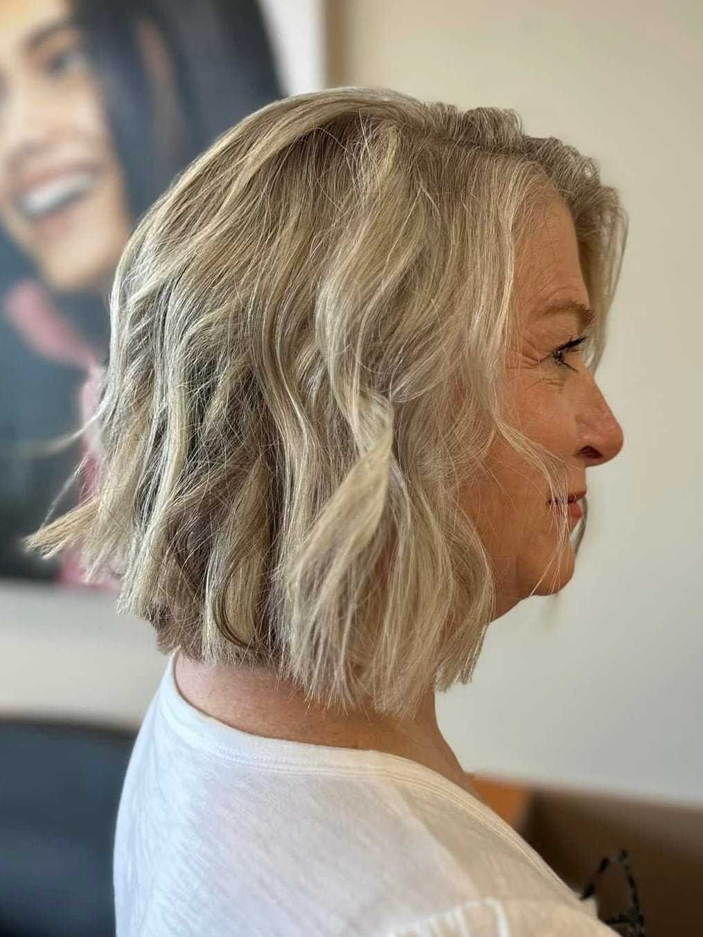 Short blonde hairstyle with soft waves, seen from the side.