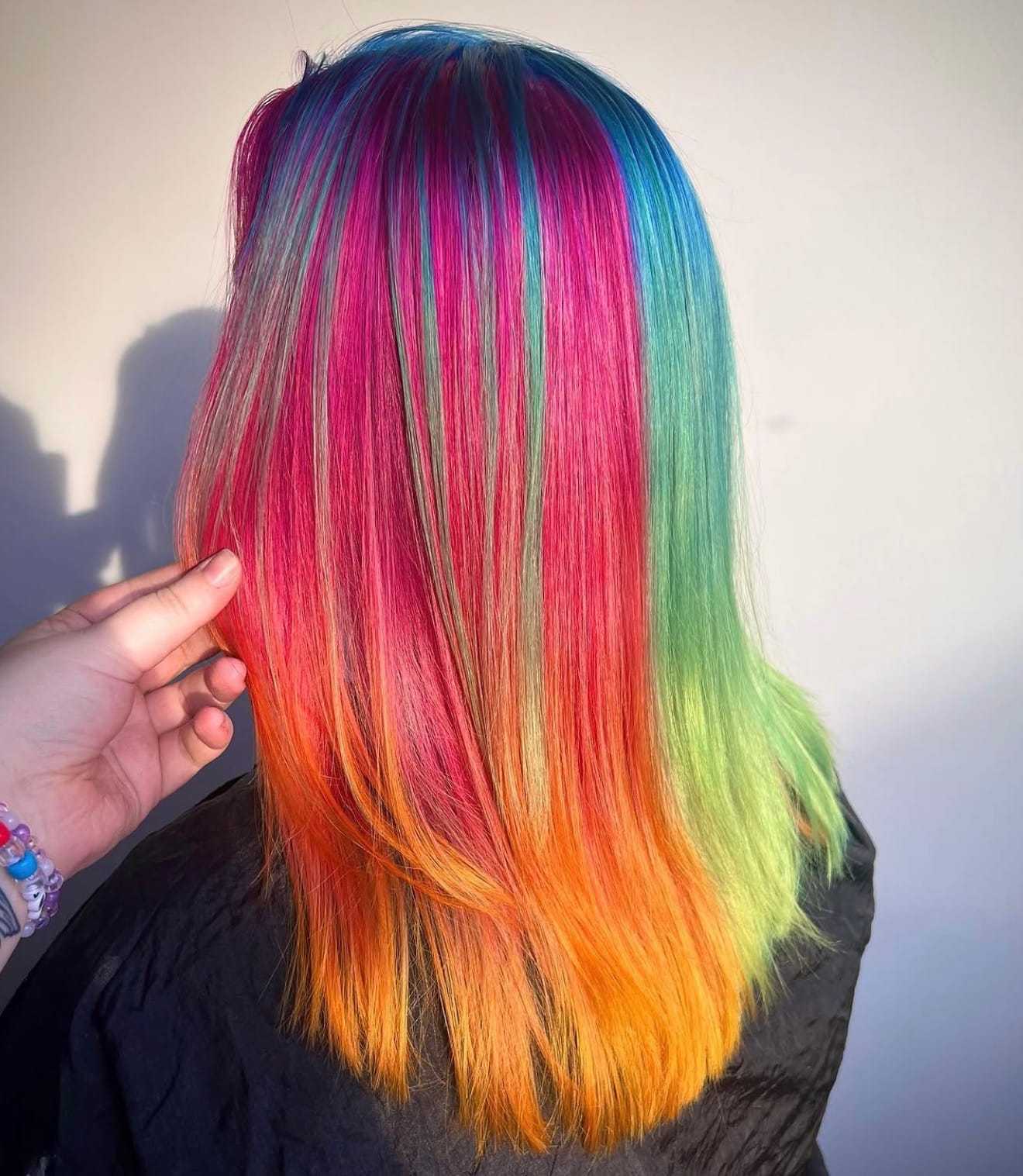 Colorful hair with vibrant rainbow shades of pink, blue, green, and orange.