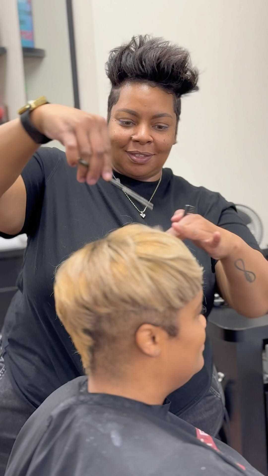 Hairstylist skillfully cutting client's hair in a salon setting.