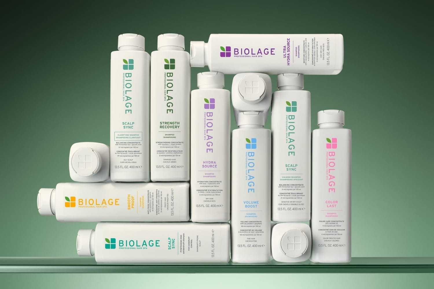 Biolage hair care products displayed against a green background.